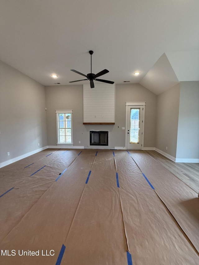 4263 S Bolivar Trl, Olive Branch, MS 38654 - unfurnished living room with a ceiling fan, a fireplace, vaulted ceiling, and baseboards
