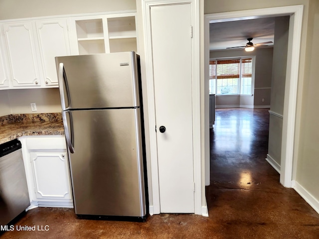 kitchen featuring white cabinets, stainless steel appliances, dark stone counters, and ceiling fan