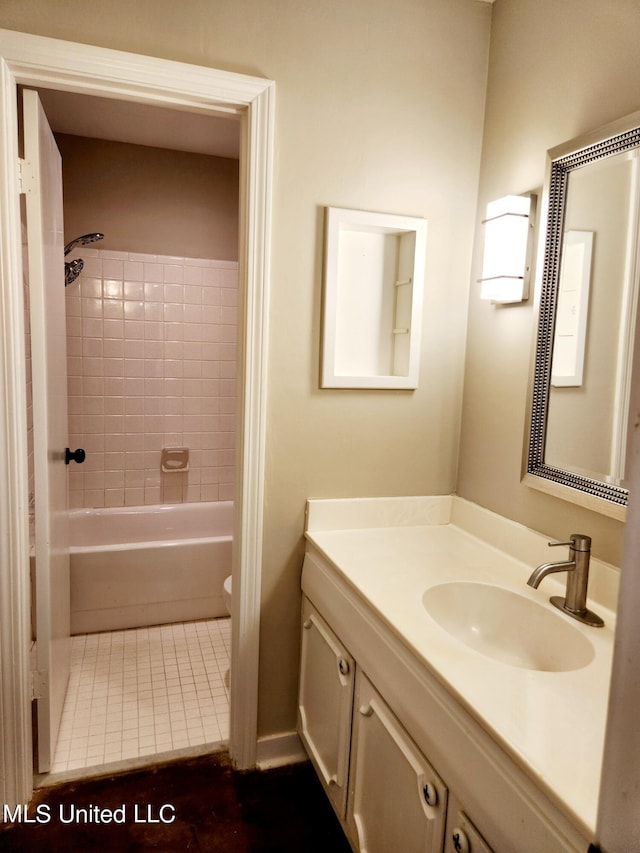 full bathroom with vanity, tiled shower / bath combo, toilet, and tile patterned flooring