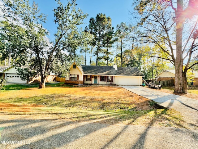 view of front of house featuring a front lawn and a garage