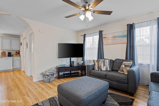 living room featuring light hardwood / wood-style floors, a healthy amount of sunlight, and ceiling fan