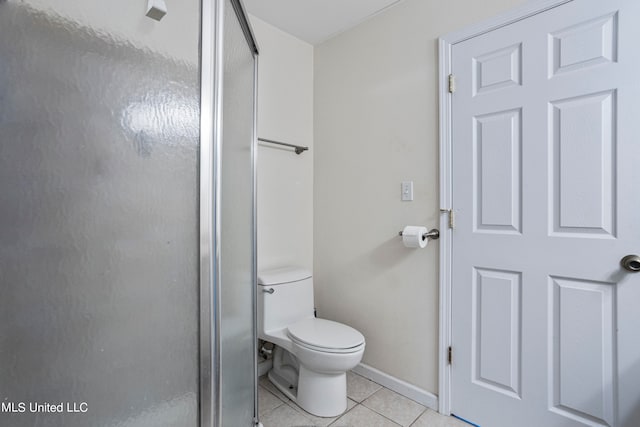 bathroom with tile patterned floors, toilet, and an enclosed shower