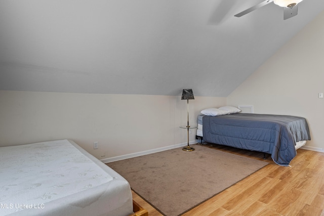 bedroom featuring lofted ceiling, hardwood / wood-style flooring, and ceiling fan