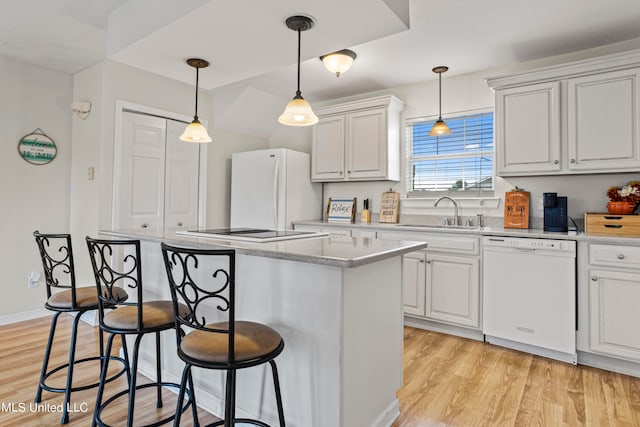 kitchen featuring white appliances, light hardwood / wood-style flooring, sink, and white cabinets