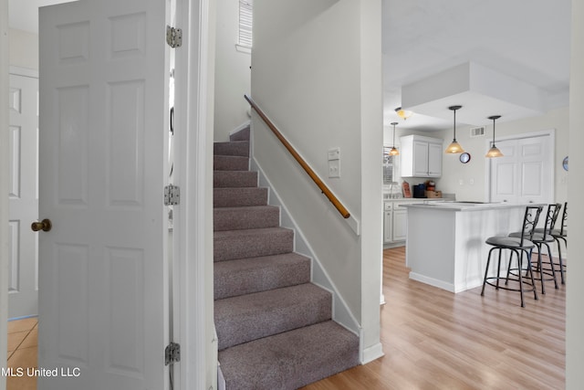 stairway with hardwood / wood-style floors