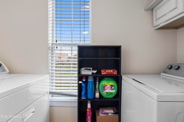 washroom featuring washer and dryer and cabinets