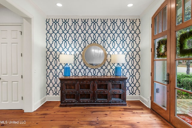 interior space with wood-type flooring and crown molding