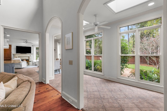 interior space featuring a skylight and ceiling fan