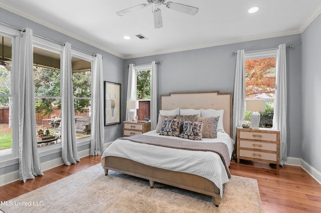 bedroom with multiple windows, ceiling fan, and light hardwood / wood-style flooring