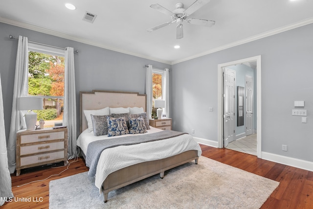 bedroom with hardwood / wood-style floors, ceiling fan, connected bathroom, and ornamental molding