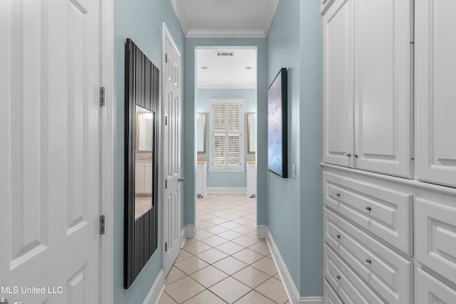 hallway with light tile patterned floors and ornamental molding