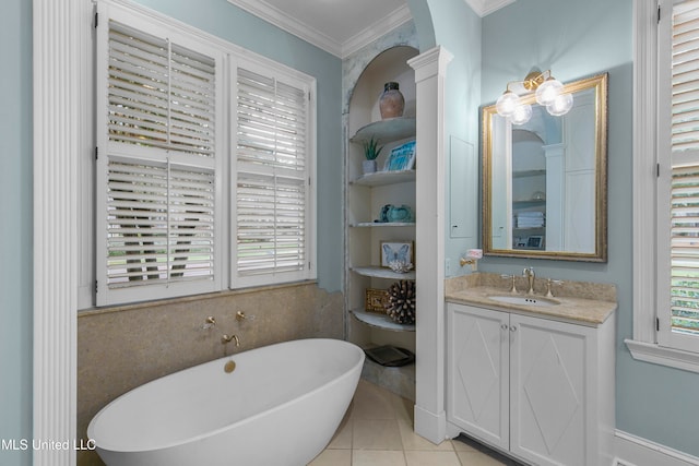 bathroom with crown molding, vanity, tile patterned floors, and a tub