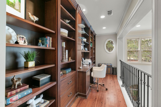 home office featuring wood-type flooring and crown molding