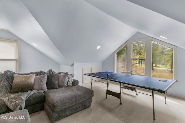 recreation room with light colored carpet and vaulted ceiling