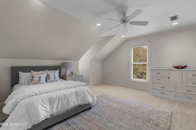 carpeted bedroom featuring ceiling fan, crown molding, and vaulted ceiling