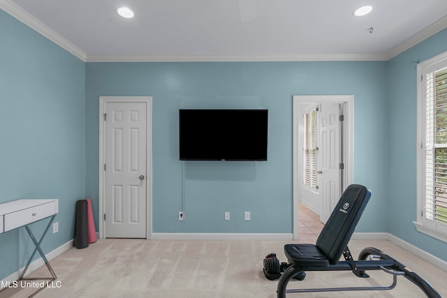 workout area with ornamental molding and light carpet