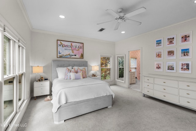 carpeted bedroom featuring ceiling fan, crown molding, and connected bathroom