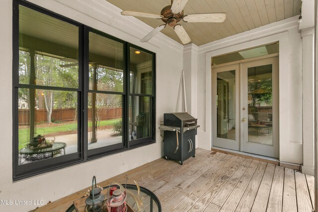 sunroom / solarium featuring french doors and ceiling fan