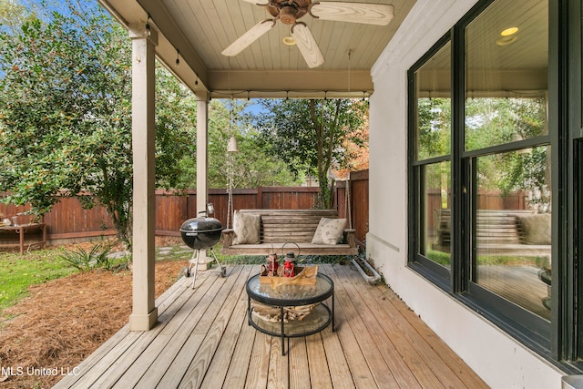 wooden terrace featuring ceiling fan