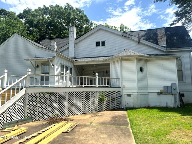 751 S Main St, Grenada, MS 38901 - rear view of property with a chimney, a lawn, crawl space, a shingled roof, and a wooden deck
