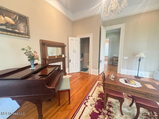 751 S Main St, Grenada, MS 38901 - sitting room with a chandelier, crown molding, wood finished floors, and baseboards