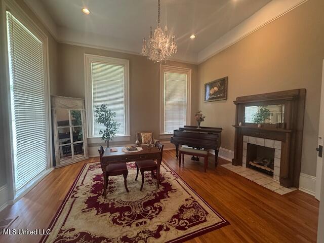 751 S Main St, Grenada, MS 38901 - office space featuring a chandelier, wood finished floors, a tile fireplace, crown molding, and baseboards