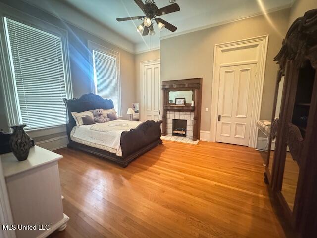 751 S Main St, Grenada, MS 38901 - bedroom featuring wood finished floors, a fireplace, baseboards, and crown molding