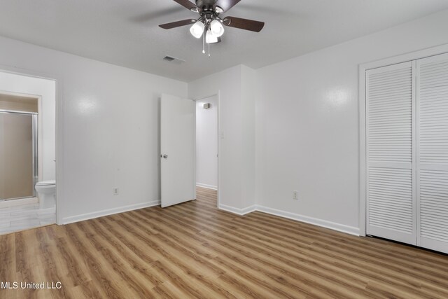 100 Grand Teton Dr, Ocean Springs, MS 39564 - unfurnished bedroom with ensuite bathroom, a closet, light wood-style floors, baseboards, and visible vents