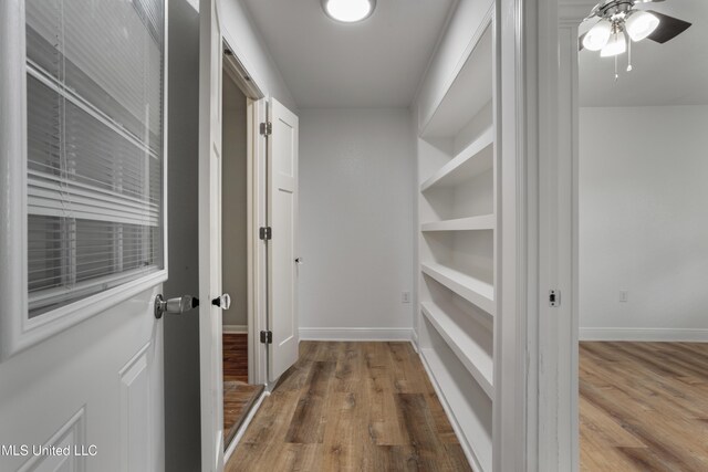 100 Grand Teton Dr, Ocean Springs, MS 39564 - hallway with baseboards, wood finished floors, and built in shelves