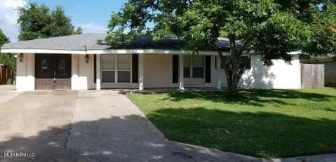 ranch-style house with a front yard and covered porch