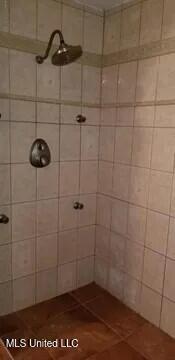 bathroom with tiled shower