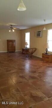 unfurnished living room featuring a wall mounted air conditioner