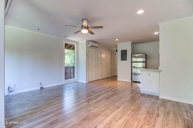229 Lakeside Villa Unit E, Diamondhead, MS 39525 - unfurnished living room featuring ceiling fan, baseboards, a wall mounted AC, ornamental molding, and electric panel
