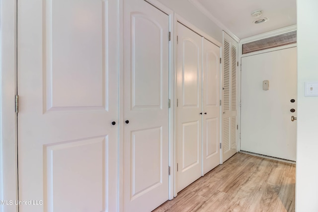 hallway with light hardwood / wood-style floors