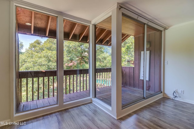 229 Lakeside Villa Unit E, Diamondhead, MS 39525 - doorway to outside featuring baseboards and wood finished floors