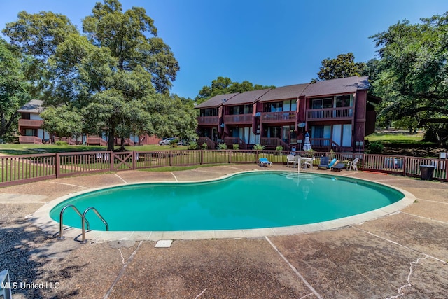 229 Lakeside Villa Unit E, Diamondhead, MS 39525 - community pool featuring a patio and fence