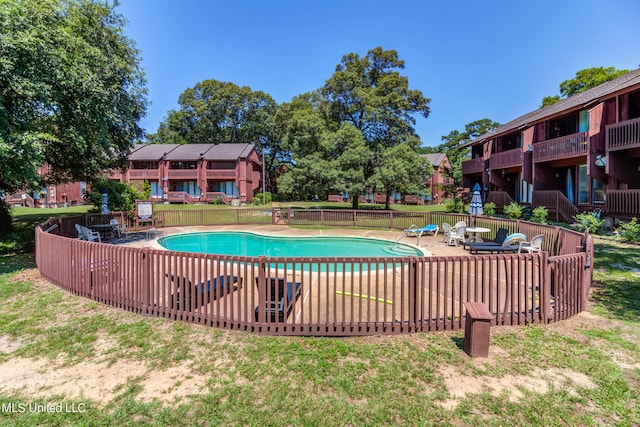 view of swimming pool featuring a yard