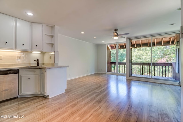 kitchen featuring dishwasher, sink, backsplash, white cabinetry, and light hardwood / wood-style flooring