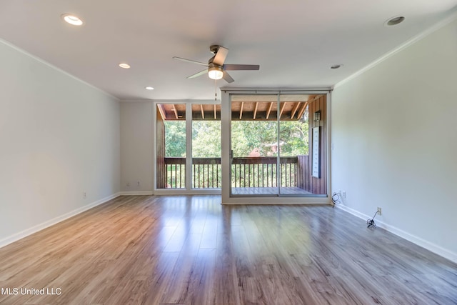 unfurnished room with crown molding, hardwood / wood-style floors, and ceiling fan