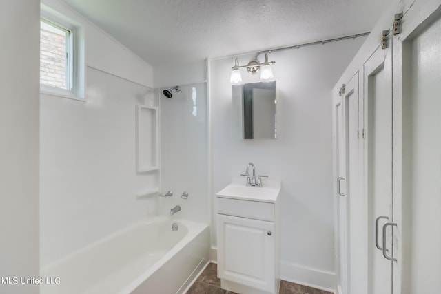 bathroom with vanity, a textured ceiling, tile patterned flooring, and shower / bath combination