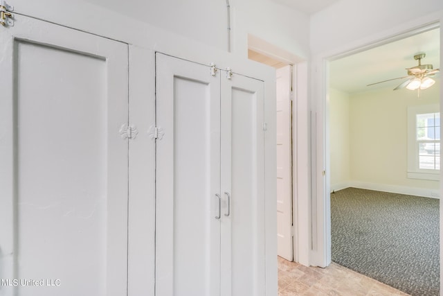 corridor with light colored carpet