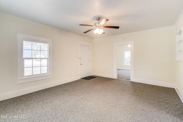 spare room featuring carpet and ceiling fan