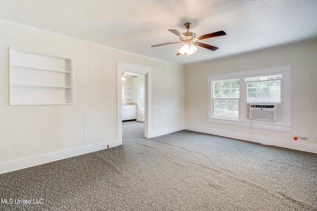 spare room with carpet, cooling unit, built in features, and ceiling fan