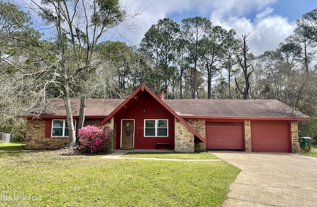 view of front of house featuring a front yard, roof with shingles, an attached garage, a chimney, and concrete driveway