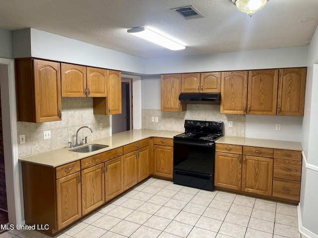 kitchen featuring visible vents, a sink, under cabinet range hood, black / electric stove, and light countertops