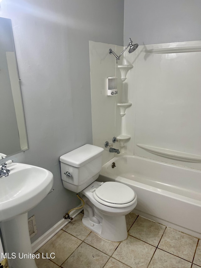 full bath with tile patterned flooring, toilet, a sink, and shower / washtub combination