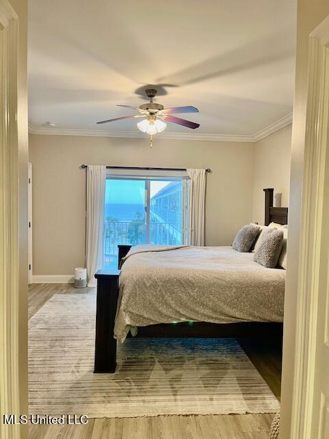 bedroom with a ceiling fan, baseboards, ornamental molding, and wood finished floors