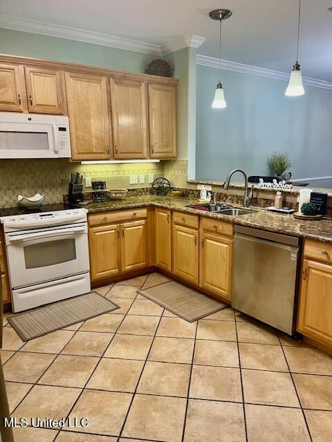 kitchen featuring crown molding, light tile patterned floors, decorative backsplash, a sink, and white appliances