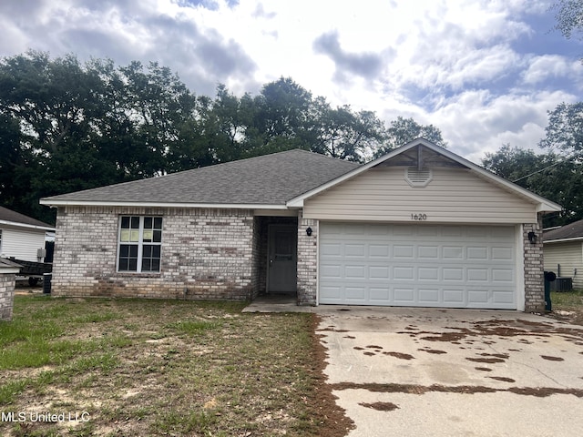 1620 Porpoise St, Ocean Springs, MS 39564 - ranch-style home featuring brick siding, driveway, an attached garage, a shingled roof, and cooling unit