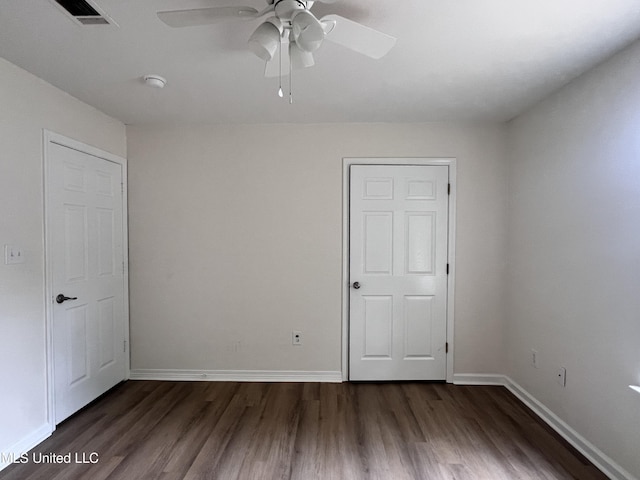 1620 Porpoise St, Ocean Springs, MS 39564 - unfurnished bedroom with dark wood-type flooring, baseboards, and a ceiling fan